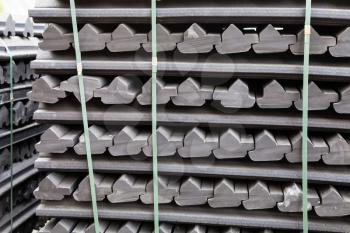 stockpiles of gray rubber retainers for rails of tram track outdoors