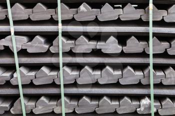 construction background - stockpile of gray rubber retainers for rails of tram track