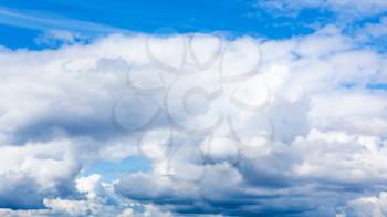 natural background - low cumulus white clouds in blue sky on summer day