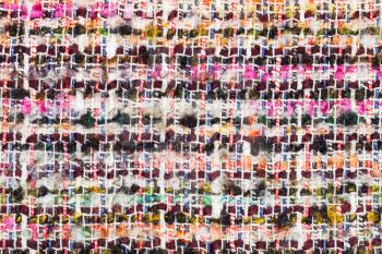 textile background - varicoloured woven yarns of boucle fabric close up