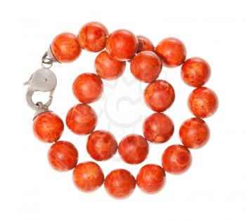 top view of tangled necklace from polished red coral balls isolated on white background