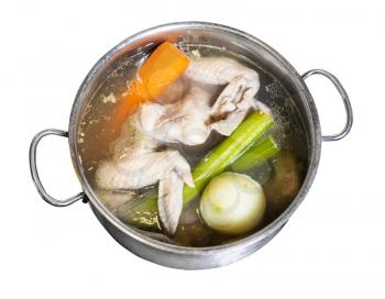 above view of chicken wings broth is cooked in steel stewpot isolated on white background