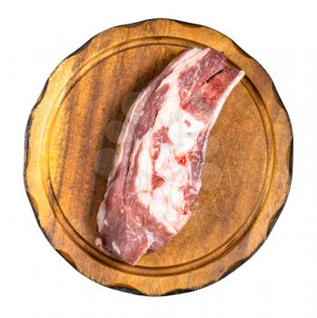 top view of raw piece of beef brisket on wooden cutting board isolated on white background