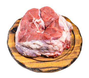 raw piece of halal beef shank on wooden cutting board isolated on white background