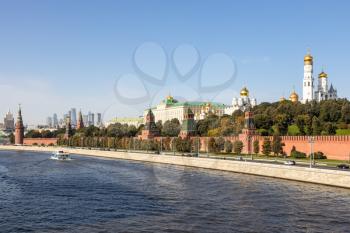 view of Kremlin embankment of Moskva River from Bolshoy Moskvoretsky Bridge on sunny autumn day