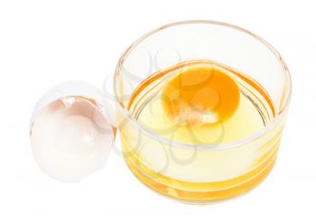 broken chicken egg in glass bowl and empty white shell isolated on white background
