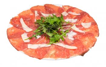 served Carpaccio (thinly sliced raw beef fillet) decorated by Parmesan, Arugula on white plate isolated on white background