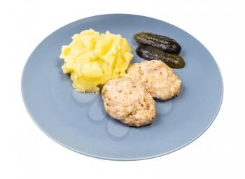 portion of homemade steamed red fish cutlets and mashed potatoes on blue plate isolated on white background