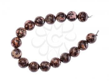 top view of string of beads from natural polished rhodonite gemstone isolated on white background