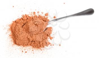 top view of pile of cocoa powder with spoon isolated on white background