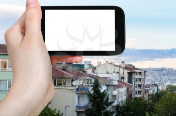 travel concept - tourist photographs of Kizilay residential district in Ankara city in spring evening in Turkey on smartphone with empty cutout screen with blank place for advertising