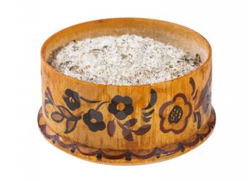 side view of wooden salt cellar with seasoned salt with spices and dried herbs isolated on white background