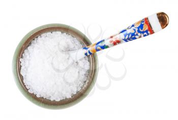 top view of ceramic salt cellar with spoon with coarse grained Sea Salt isolated on white background