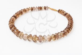 necklace from faceted Smoky quartz gemsones on white paper background