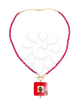 top view of hand crafted necklace from red agate beads with square pendant from red horn and brass ball isolated on white background