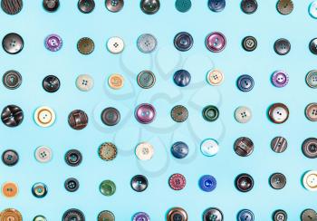 top view of various buttons arranged on blue background