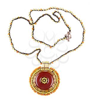 handcrafted necklace with round brown leather pendant embroidered by glass beads and bugles isolated on white background