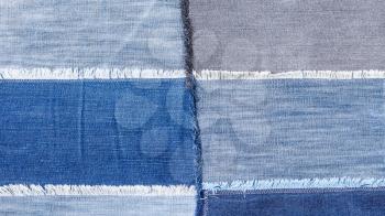 textile panoramic background - patchwork from various denim flaps close up