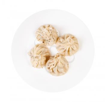 georgian cuisine - top view of peppered khinkali on white plate isolated on white background