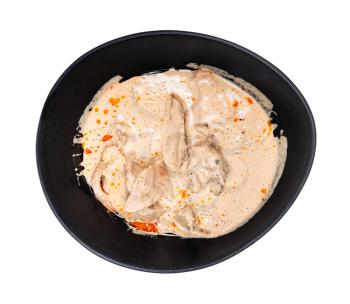 georgian cuisine - top view of Satsivi (spicy cold appetizer from chicken in walnut sauce) in black bowl isolated on white background