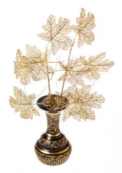 artificial plastic twigs of tree in carved indian vase isolated on white background