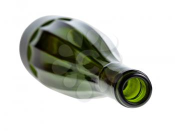 overturned empty faceted green wine bottle isolated on white background