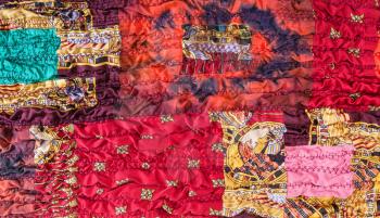 pattern of stitched crumpled red brown patchwork scarf