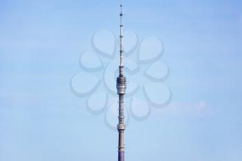 top of Ostankinskaya TV tower and blue sky on sunny day in Moscow city