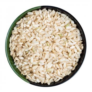 top view of unpolished brown rice in round bowl isolated on white background