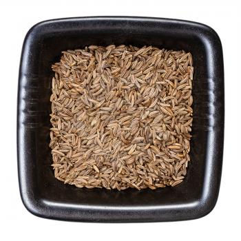 top view of caraway seeds in black bowl isolated on white background