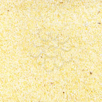 square food background - uncooked soft wheat manna groats close up