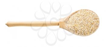wooden spoon with crushed pot barley groats isolated on white background