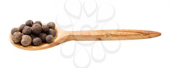 wooden spoon with allspice jamaica peppers isolated on white background
