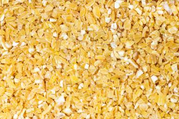 food background - top view of raw crushed polished wheat grains