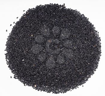 top view of pile of Nigella sativa seeds (black caraway) on gray ceramic plate