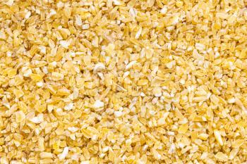 food background - uncooked crushed polished wheat grains