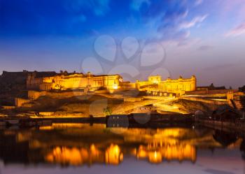 Amer Fort Amber Fort illuminated at night - one of principal attractions in Jaipur, Rajastan, India refelcting in Maota lake in twilight