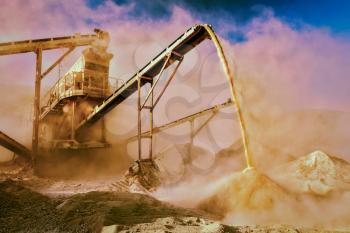 Vintage retro effect filtered hipster style image of Industrial background - crusher rock stone crushing machine at open pit mining and processing plant for crushed stone, sand and gravel