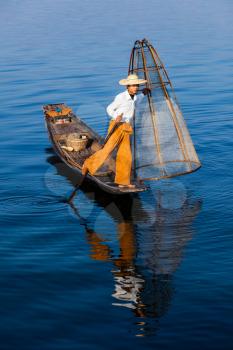 Myanmar travel attraction landmark - Traditional Burmese fisherman at Inle lake, Myanmar famous for their distinctive one legged rowing style