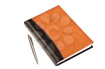 Diary for 2012 year  with leather cover and metal pen on table isolated on white background