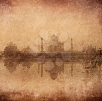 Vintage retro hipster style image of Taj Mahal with reflection in Yamuna river panorama in fog, Indian Symbol - India travel background with grunge texture overlaid. Agra, Uttar Pradesh, India