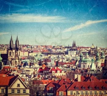 Vintage retro hipster style travel image of aerial view of Prague, Czech Republic with grunge texture overlaid