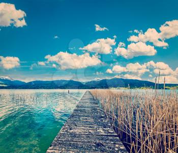 Vintage retro effect filtered hipster style travel image of pier in the lake in countryside, Bavaria, Germany