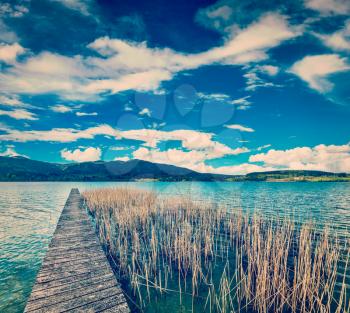 Vintage retro effect filtered hipster style travel image of pier in the lake in countryside, Bavaria, Germany