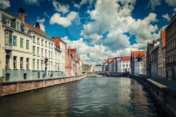 Vintage retro hipster style travel image of canal and old houses in Bruges (Brugge), Belgium