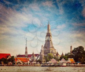 Vintage retro hipster style travel image of Buddhist temple (wat) Wat Arun on Chao Phraya River with grunge texture overlaid. Bangkok, Thailand
