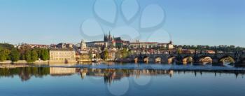 View of historic center of Prague Charles bridge over Vltava river and Gradchany Prague Castle and St. Vitus Cathedral in the morning
