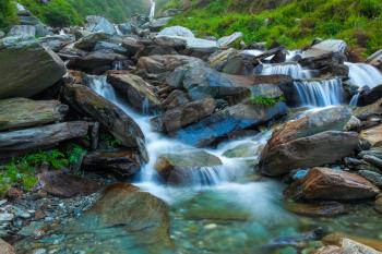 Cascade of Bhagsu waterfall in Himalayas. Bhagsu, Himachal Pradesh, India. Polarizer filter used