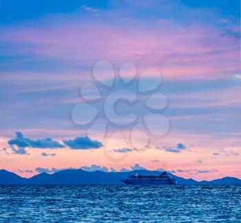 Vacation cruise background - sunset sea with cruise ship. Andaman sea, Thailand