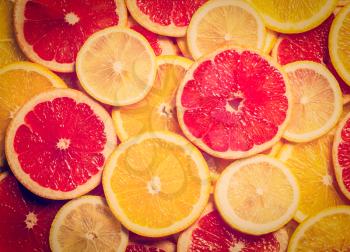 Vintage retro effect filtered hipster style image of colorful citrus fruit - lemon, orange, grapefruit - slices background